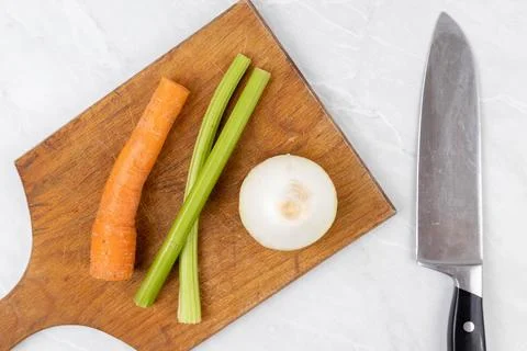 Flat lay above Carrot Celery and Onion on the wooden board Foto stock