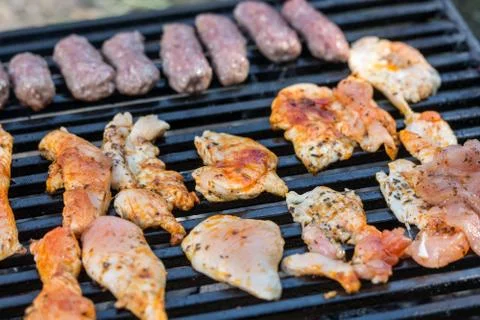 Flat lay above chicken white breast meat on the barbecue grill with kebabs Stock Photos
