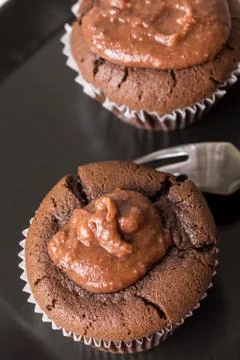 Flat lay above chocolate cup cake muffin on the black square plate Stock Photos