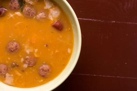 Flat lay above cooked beans with sausages on the wooden table with copy space Stock Photos