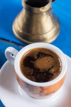 Flat lay above cup of coffee on the blue background table. Stock Photos