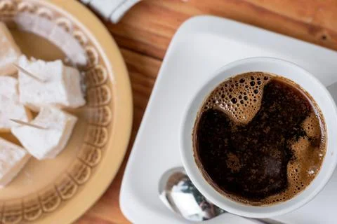 Flat lay above cup of coffee with turkish delight on the table Stock Photos