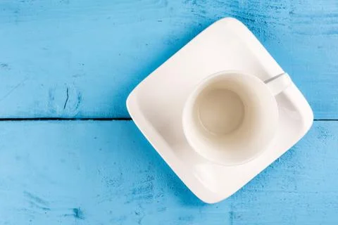Flat lay above empty cup for coffee on the blue wooden table Stock Photos