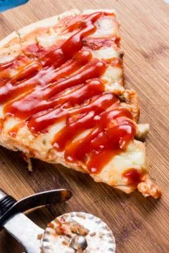 Flat lay above fresh baked pizza triangle slice on the wooden board with cutt Foto stock