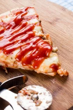 Flat lay above fresh baked pizza triangle slice on the wooden board with cutt Stock Photos