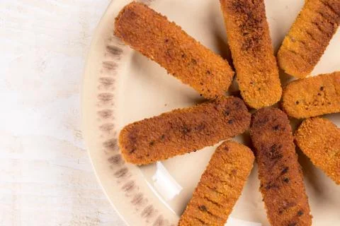 Flat lay above fried fish meat sticks on the plate Stock Photos