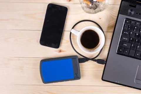 Flat lay above lap top computer on the wooden table with external hard disc h Stock Photos