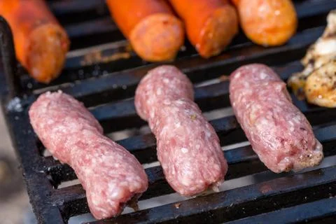 Flat lay above minced meat kebabs frying on the barbecue grill Stock Photos