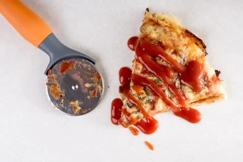 Flat lay above pizza round knife and slice of pizza with mushrooms Stock Photos