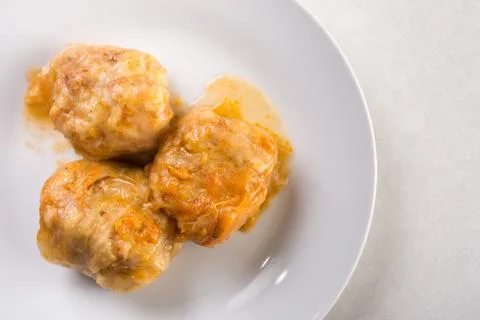 Flat lay above served sarma, cabbage stuffed with minced meat on the white ma Stock Photos