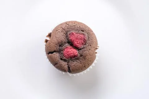 Flat lay above white plate with chocolate cup cake muffin with raspberries Stock Photos