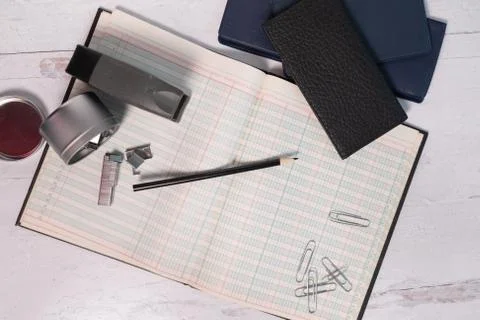 Flat lay accounting ledger with office supplies scattered Stock Photos