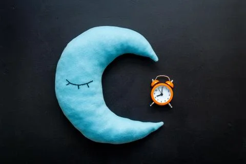 Flat lay of alarm clock and pillow, top view Stock Photos