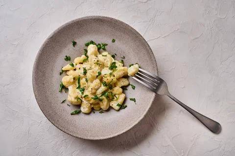 Flat lay Alpine dish gnocchi, prepared with potato and whole grain flour dough Stock Photos