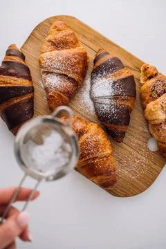 Flat lay of appetizing brown and chocolate croissants are sprinkled with Stock Photos