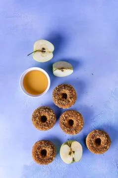 Flat lay with apple cider doughnuts on purple Stock Photos