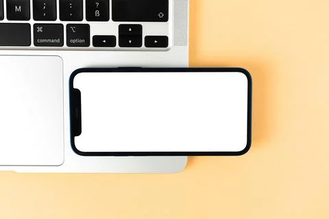 Flat lay Apple iPhone horizontally mockup, office desktop with laptop, beige  Stock Photos