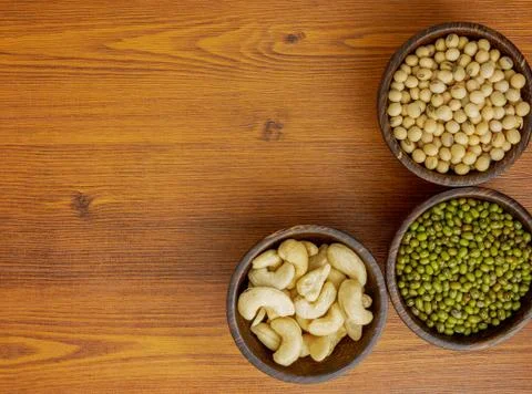 Flat lay assorted beans on wooden table Stock Photos