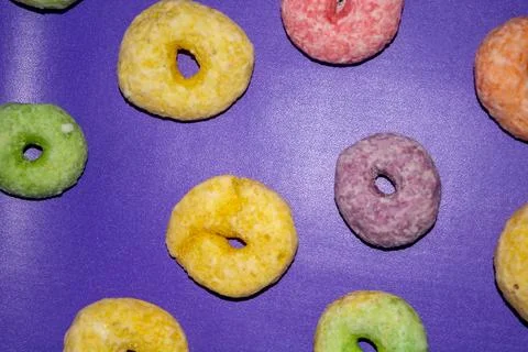Flat lay of assorted-color sweet donuts that look delicious on a pink backg.. Stock Photos