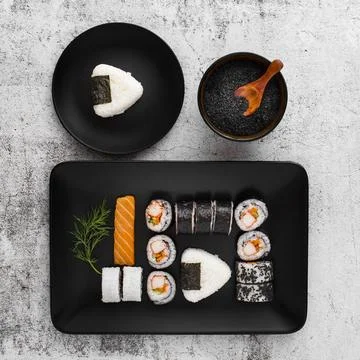 Flat lay assortment sushi black rectangular plate with copy space 스톡 사진
