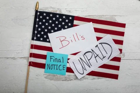 Flat lay background of american flag with bills unpaid final notice Stock Photos