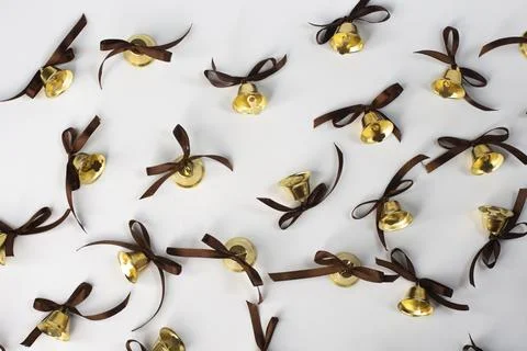 Flat lay background of shiny bells with bow hangers. on white background Stock Photos