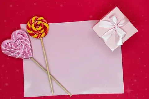 Flat lay background for valentine's day. Sweet lollipops and gift box Stock Photos