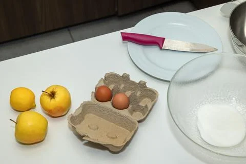 Flat lay baking ingredients on kitchen counter with fruit,eggs, and kitchen.. Stock Photos