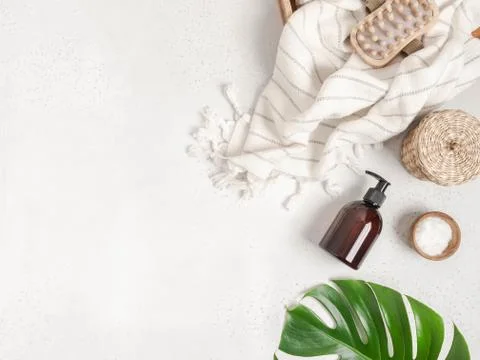 Flat lay of bath accessories and products on light gray background. Stock Photos