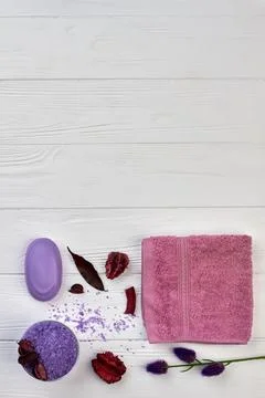Flat lay bath spa accessories on white wooden desk. Stock Photos