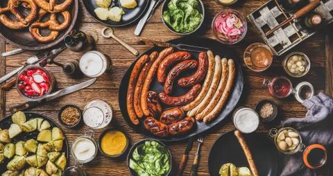Flat-lay of Bavarian Octoberfest dinner with beers, sausages and snacks Stock Photos