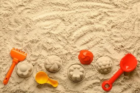 Flat lay of beach toy kit on sand, space for text. Outdoor play 写真素材