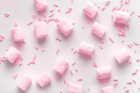 Flat lay of beautiful marshmallows and sprinkles, soft pink background 스톡 사진