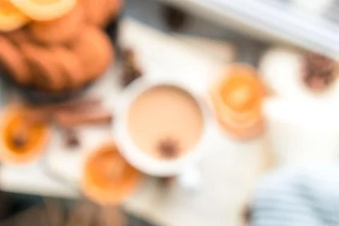 Flat lay with big cup of coffee, book and knitted blankets by the window Stock Photos