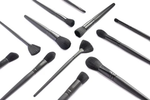 Flat lay of black makeup brushes collection isolated on white background Stock Photos