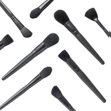 Flat lay of black makeup brushes isolated on white background Stock Photos