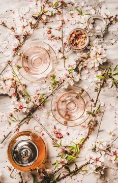 Flat-lay of black tea and blooming spring flowers, white background Stock Photos