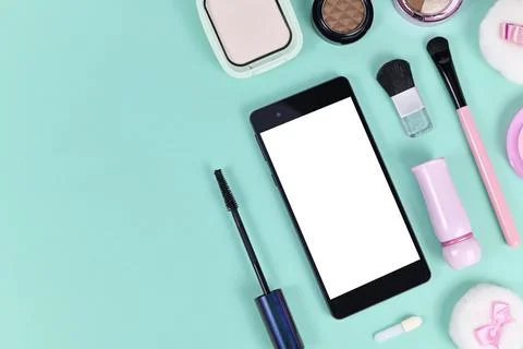 Flat lay with blank black smart phone with empty white screen surrounded by Stock Photos