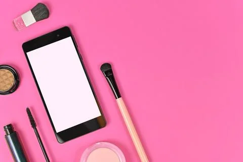 Flat lay with blank black smart phone with empty white screen and makeup beauty Stock Photos