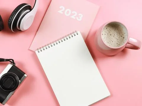 Flat lay of blank paper note book on pink diary or planner 2023, headphones.. Stock Photos