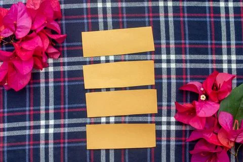 Flat Lay Blank Paper Strips and Pink Bougainvillea Flowers on Plaid Fabric Backg Stock Photos