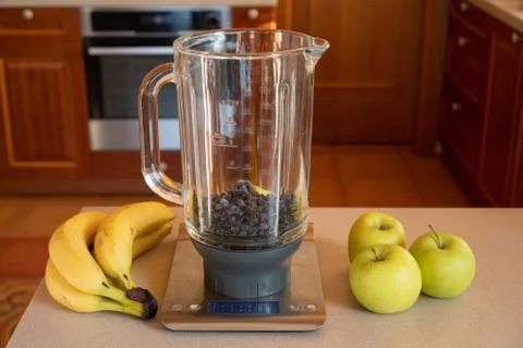 Flat-lay of a blender on a kitchen digital scales with blueberries and around Stock Photos