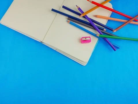 Flat lay blue desk and colored pencils Stock Photos