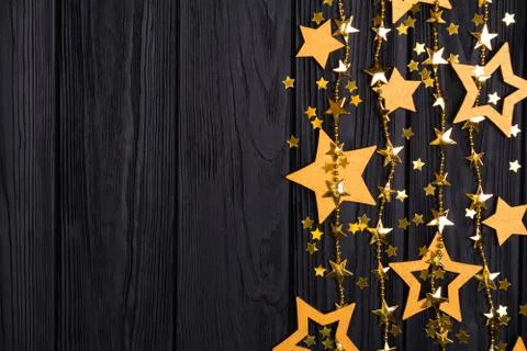 Flat lay border of big and small stars of confetti. Stock Photos