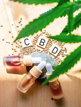 Flat lay bottles with Cannabis CBD oil with Medical Marijuana plant leafs and Stock Photos