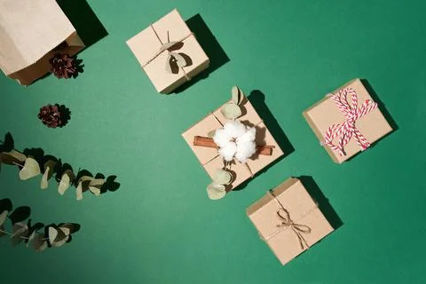 Flat lay boxes with decoration dry cotton, eucalyptus leaves and rope on green Stock Photos