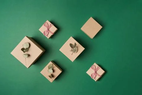 Flat lay boxes with decoration of eucalyptus leaves and rope on green background Stock Photos
