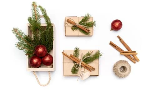 Flat lay boxes with fir tree, cinnamon, rope, New Year balls on white Stock Photos