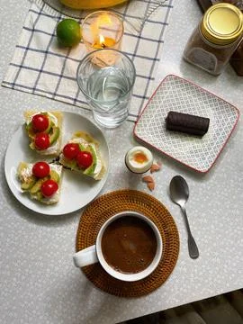 Flat lay breakfast with a large mug of coffee, avocado and cherry Stock Photos