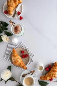 Flat lay of a breakfast table with croissants, coffee, fruit, boiled egg 写真素材